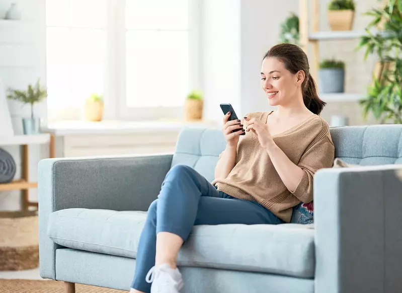 woman on phone on couch