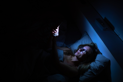 woman looking at phone at night