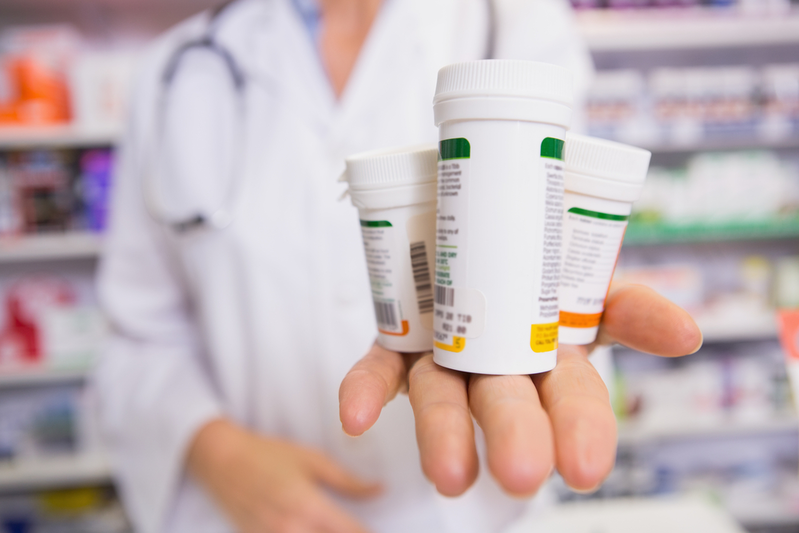 pharmacist holding bottles in palm